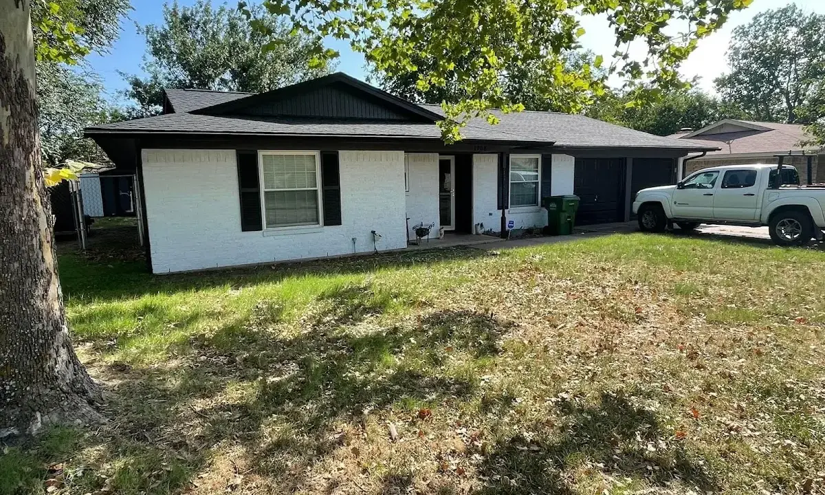 Professional roofing crew working on a residential roof in Borger